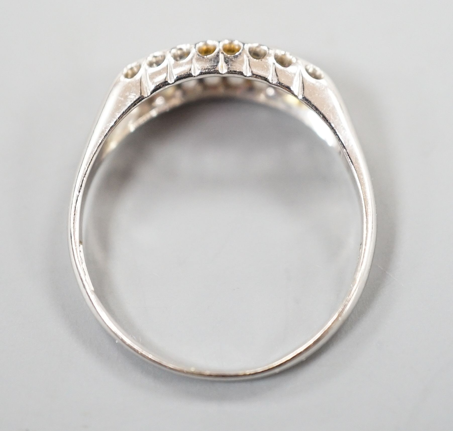 A George V 18ct white gold three stone ruby and two stone diamond ring, size P/Q, gross weight 2.3 grams.